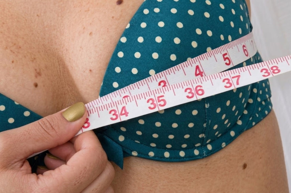 a woman is measuring her bra size